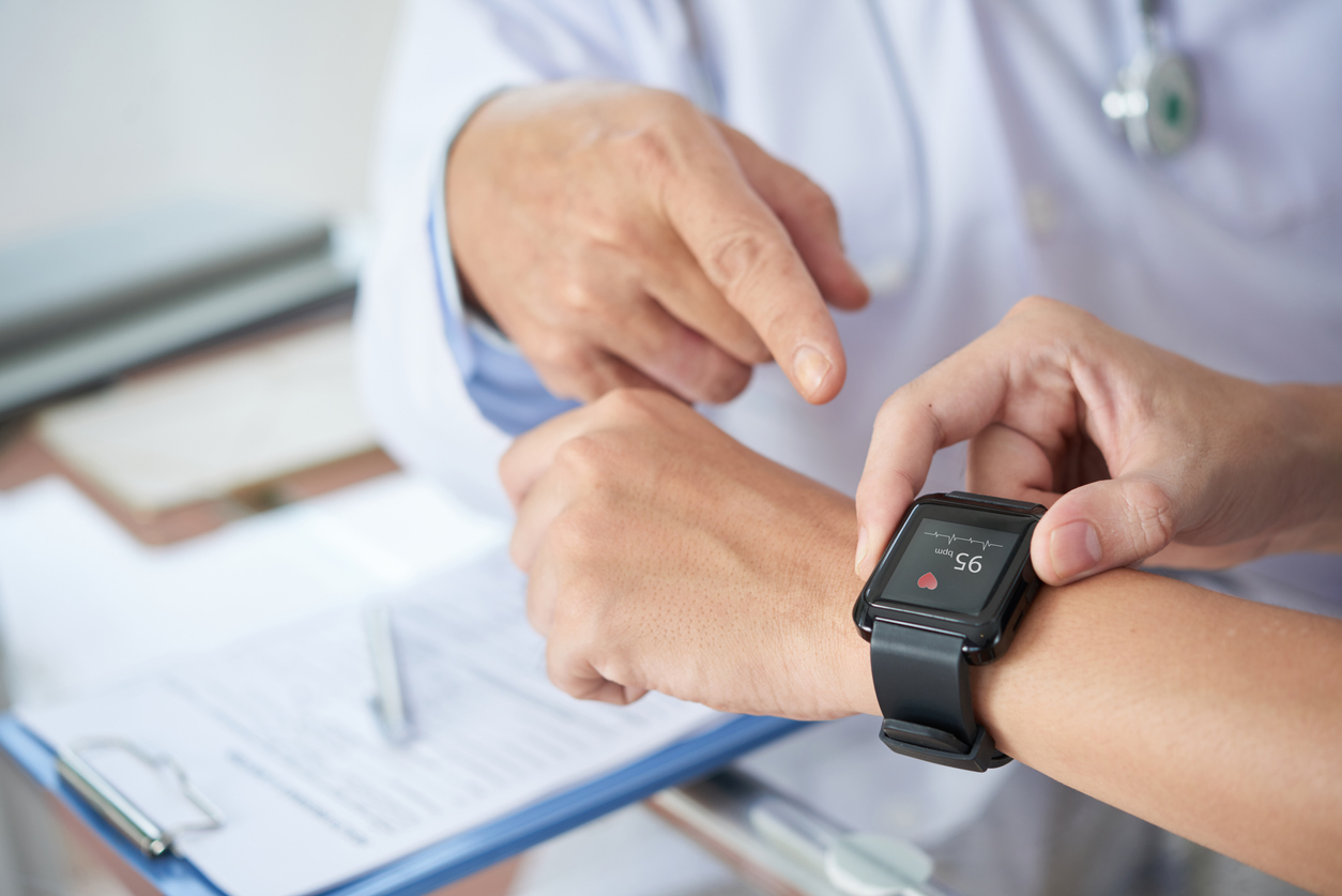 doctor using healthcare wearables to optimize treatment