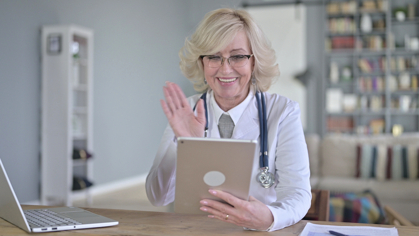 female doctor using a medical tablet as a piece of patient engagement technology