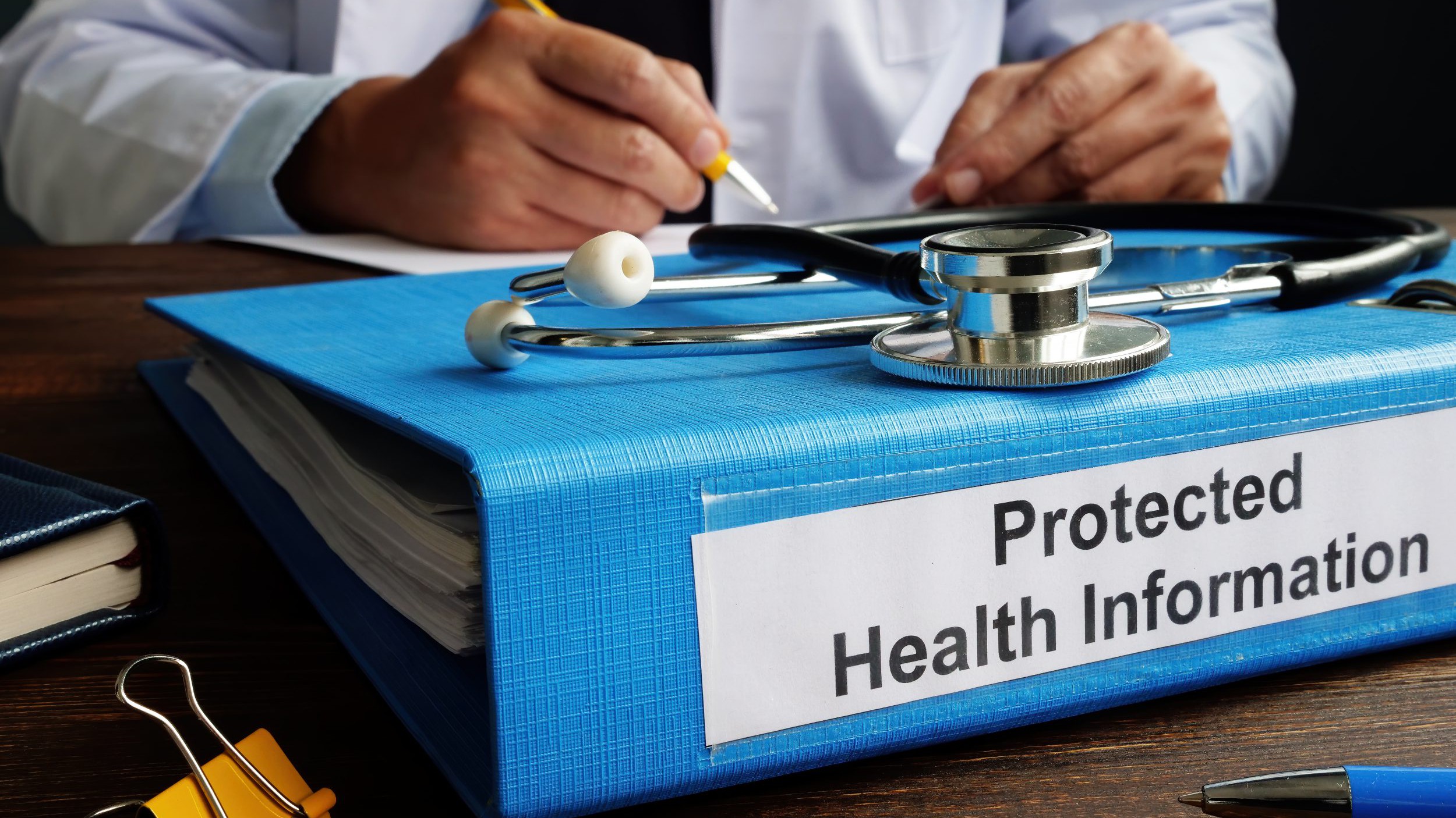 Blue Folder with protected health information PHI as part of HIPAA rules.