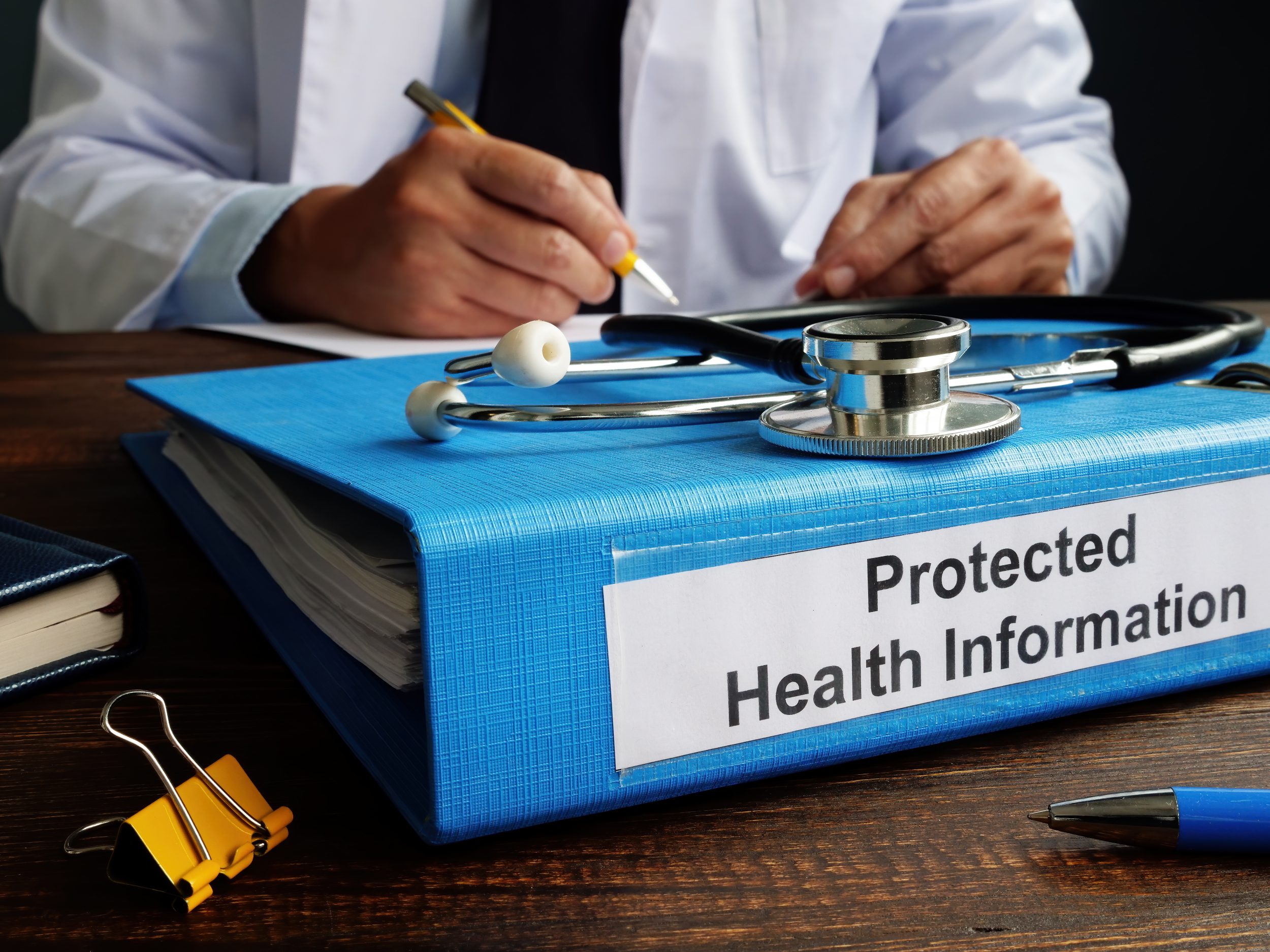 Blue Folder with protected health information PHI as part of HIPAA rules.