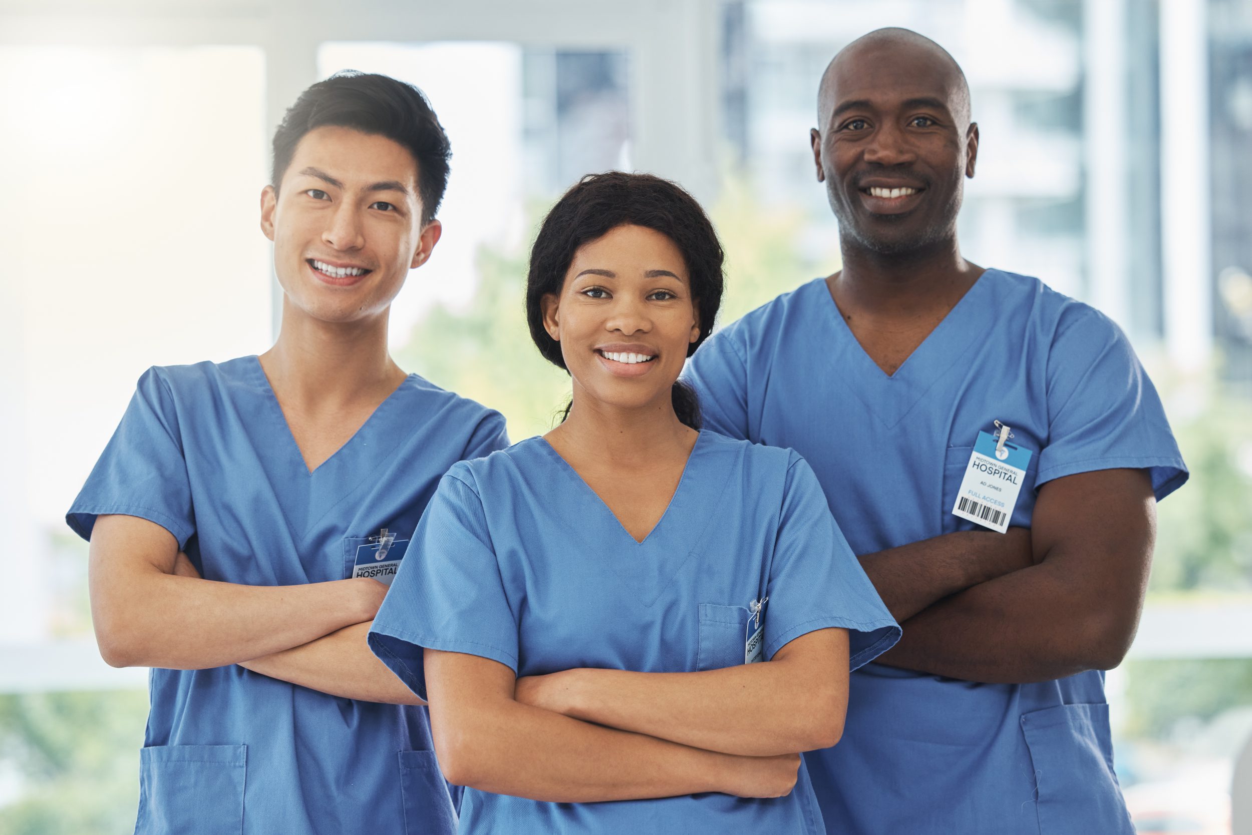 Portrait of a group of medical practitioners like nurses standing together with their arms crossed