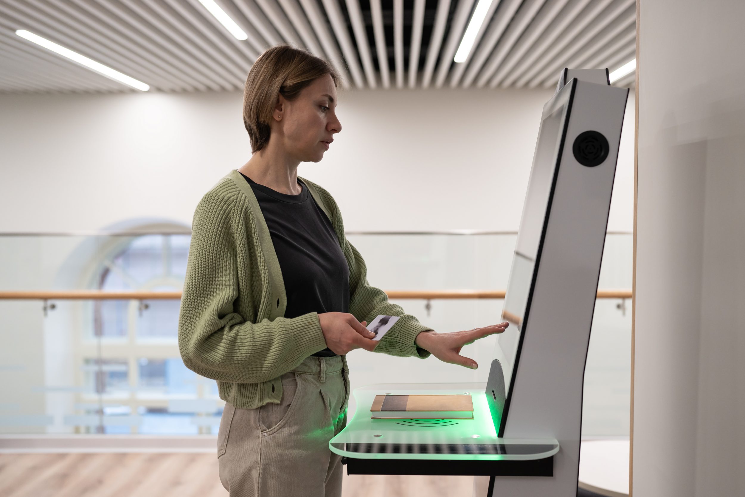 Middle-aged woman using self-service terminal