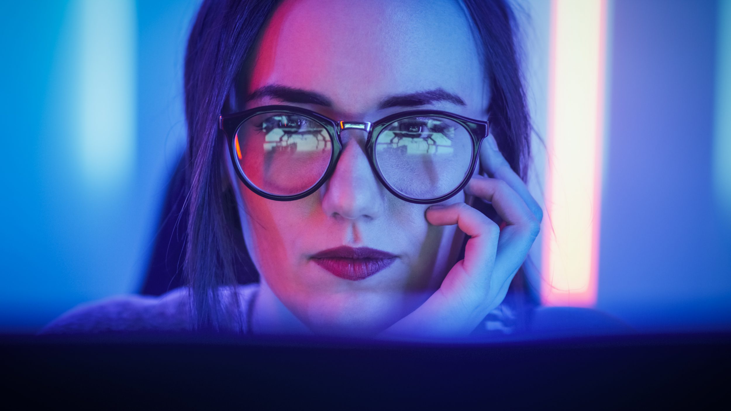 Beautiful Young Girl Sitting Before Computer Screen, screen glare on glasses