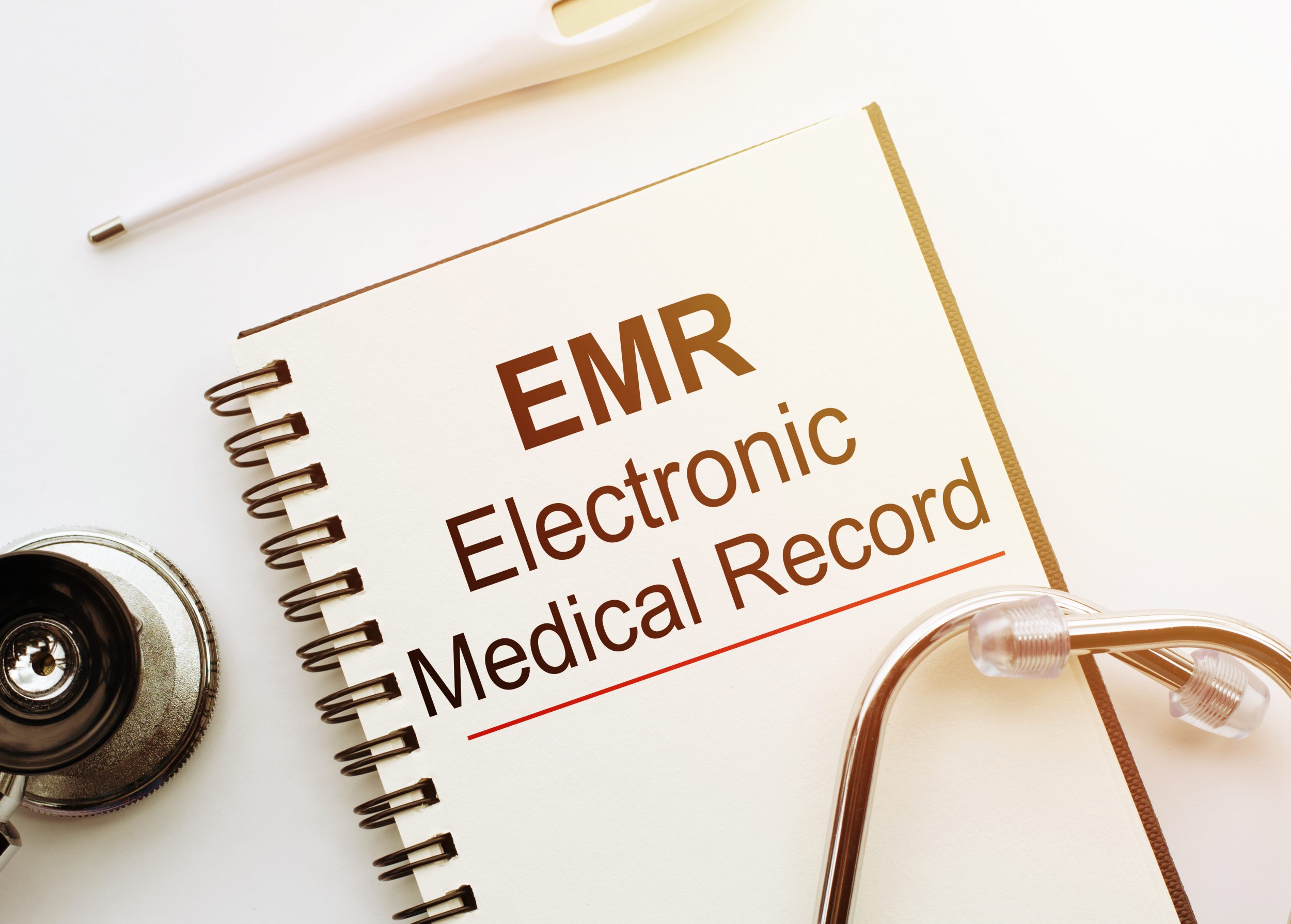 Blank with EMR or electronic medical record text from EMR systems on table
