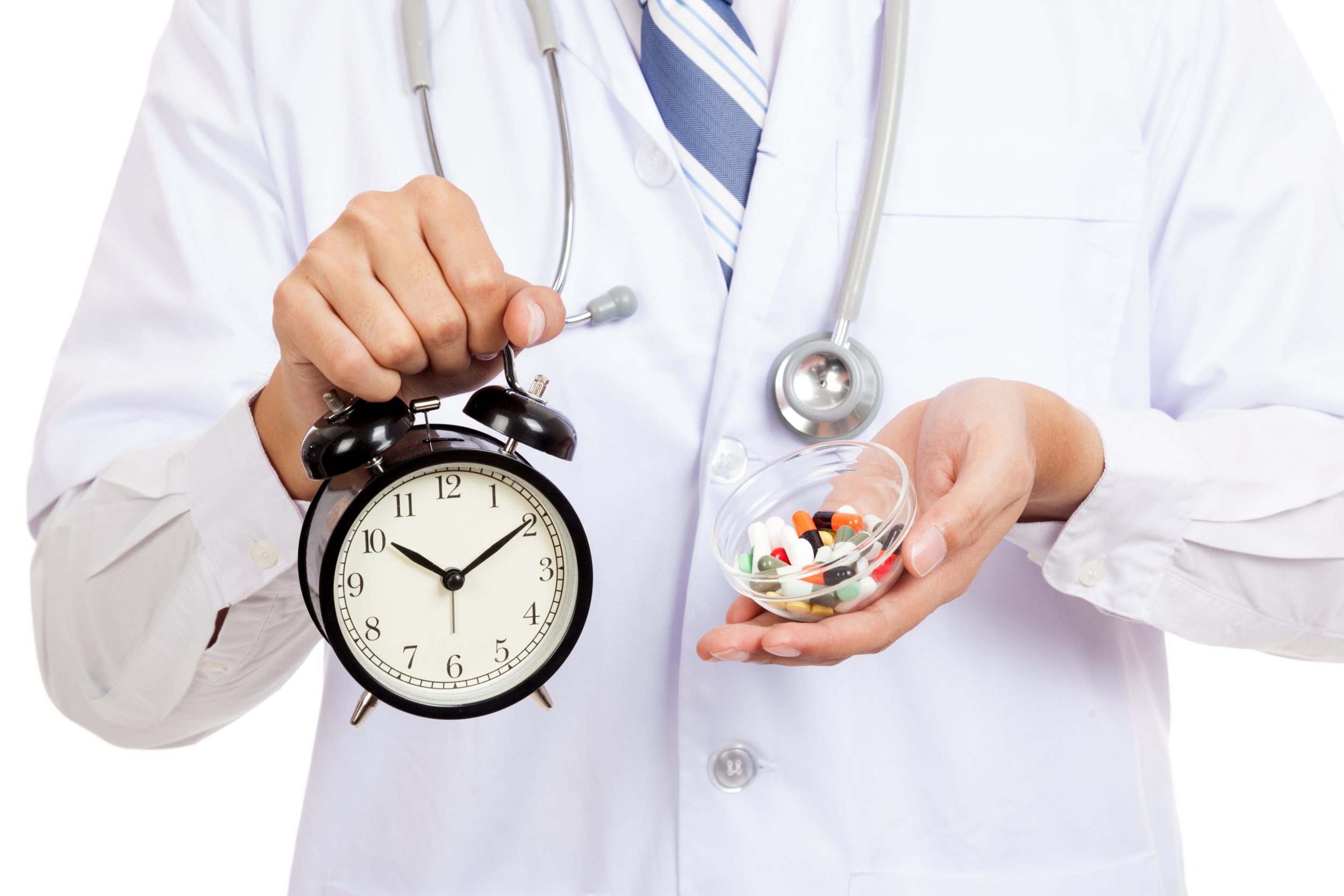 Early Diagnosis Close up of Asian male doctor show a clock and pills