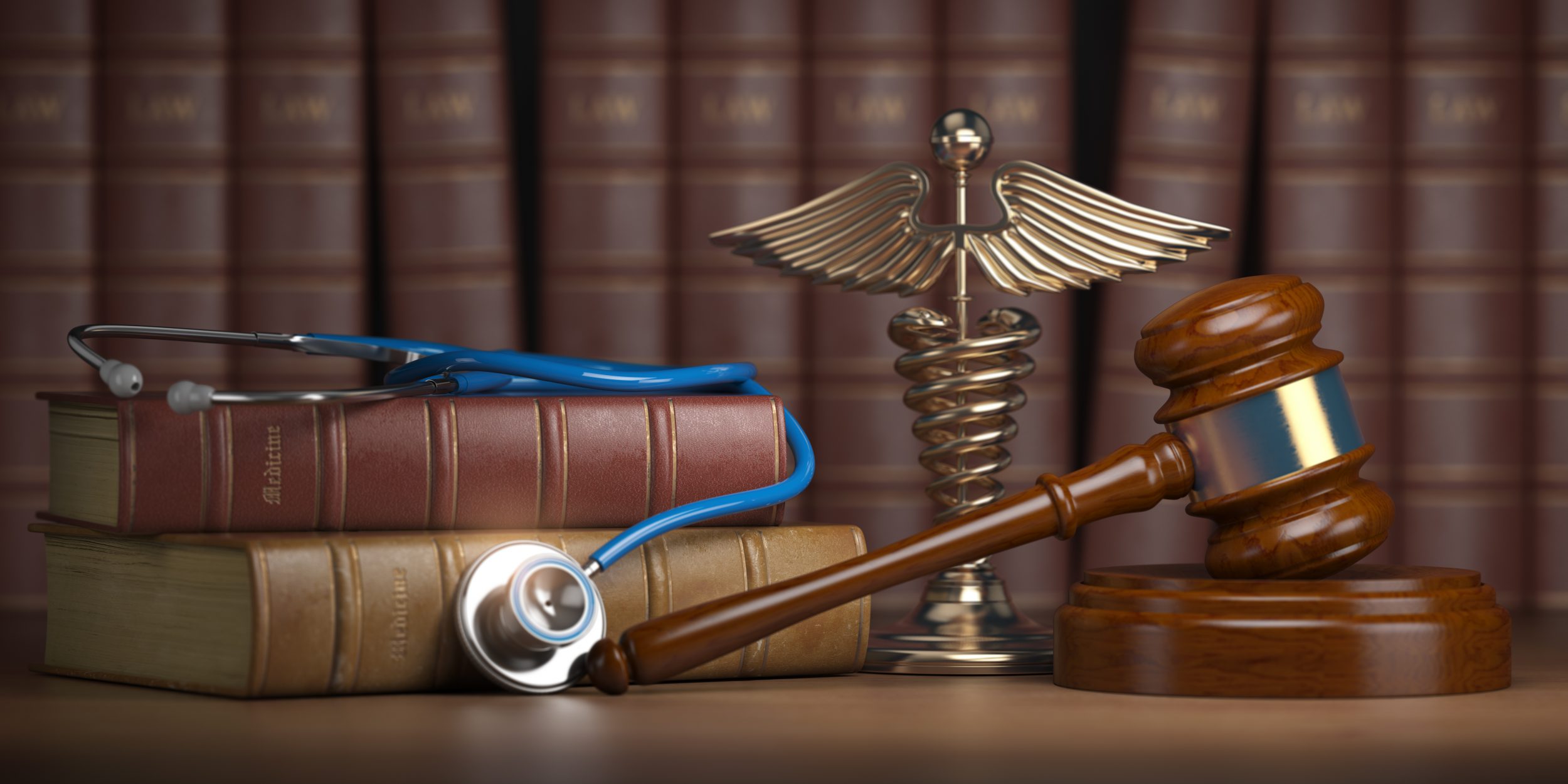 Gavel, stethoscope and caduceus sign on books background on who enforces HIPAA