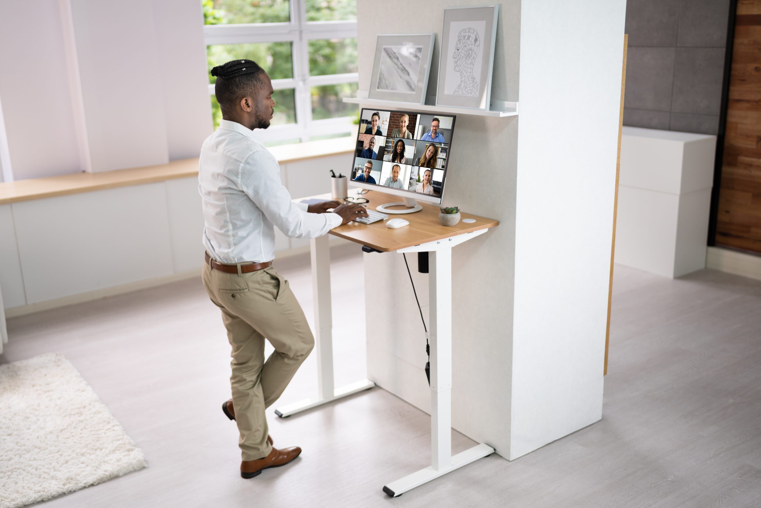 Adjustable Height Desk Stand In Office Using all in one PC desktop Computer