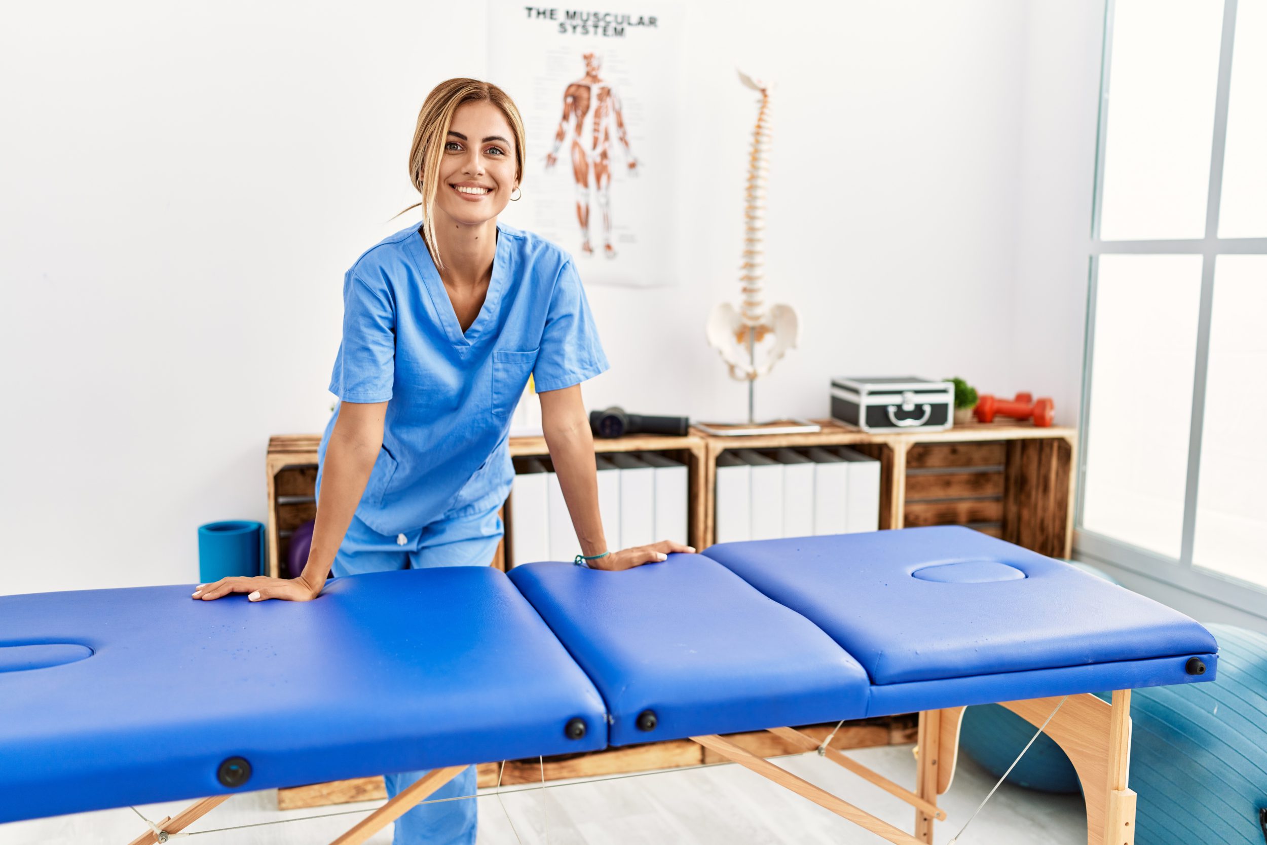 chiropractor leaning on table sourced from chiropractic equipment list